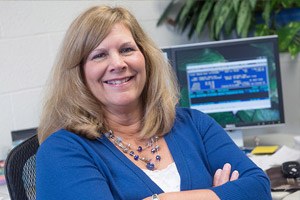 Woman smiling at her office desk.