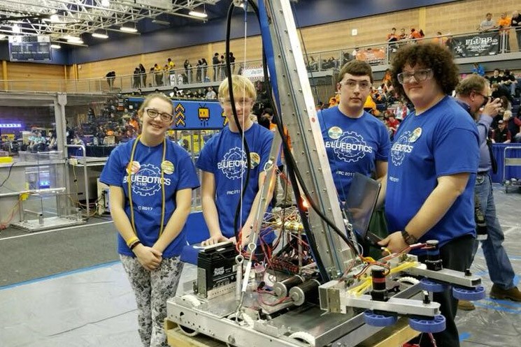 Group of Adrian High School students working on a project in the gym.