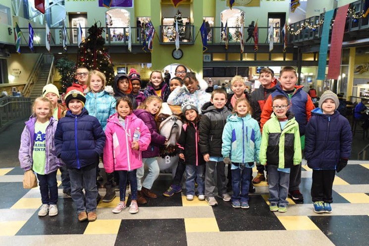 Group of Prairie elementary students stand and smiling.